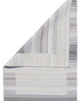 Classic Artistic Gray Flatweave Wool & Viscose Rug, its subtle gray tones and flatweave construction blending seamlessly within a bright, modern living room.