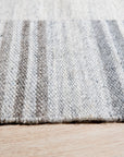 Classic Artistic Gray Flatweave Wool & Viscose Rug, offering a textured gray expanse with subtle sheen, lies elegantly on a light wood floor, enhancing the room's modern aesthetic.