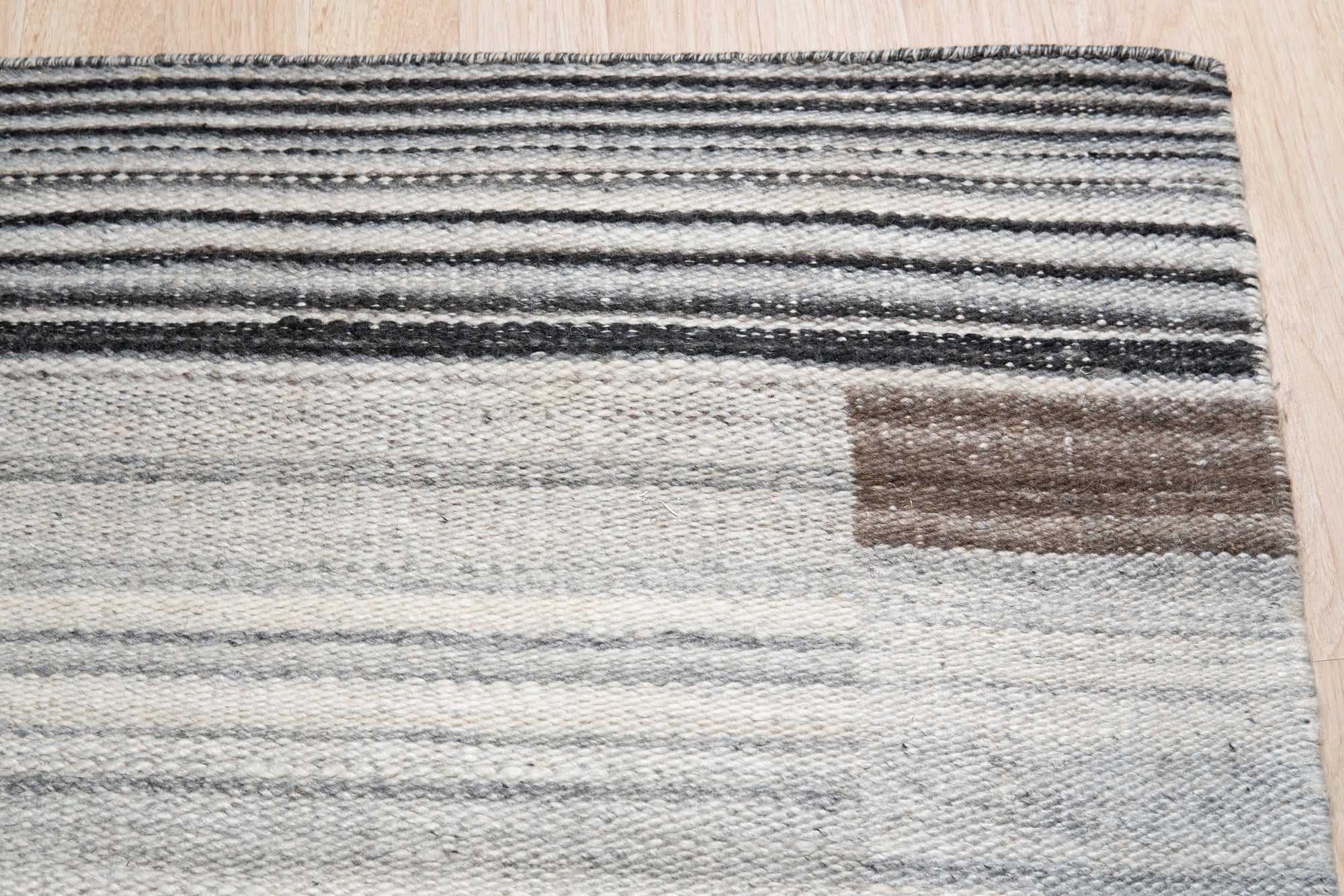 Classic Reversible Delicate Brown Flatweave Wool & Viscose Rug, showing a subtle geometric pattern in warm browns and creams, adding texture and sophistication to a living space with light wood floors.
