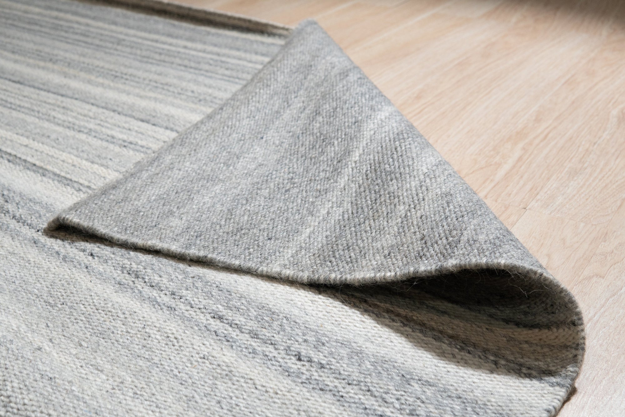 Classic Reversible Delicate Brown Flatweave Wool & Viscose Rug, a brown wool and viscose rug with a subtle, possibly geometric or textured, flatweave design, seen in a bright, modern living room setting.