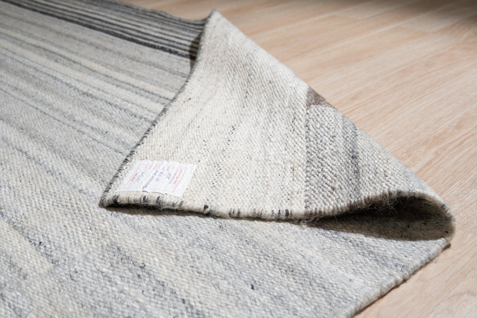 Classic Reversible Delicate Brown Flatweave Wool & Viscose Rug, a delicate brown flatweave rug blending wool and viscose fibers, complements a light, airy room with neutral furniture.
