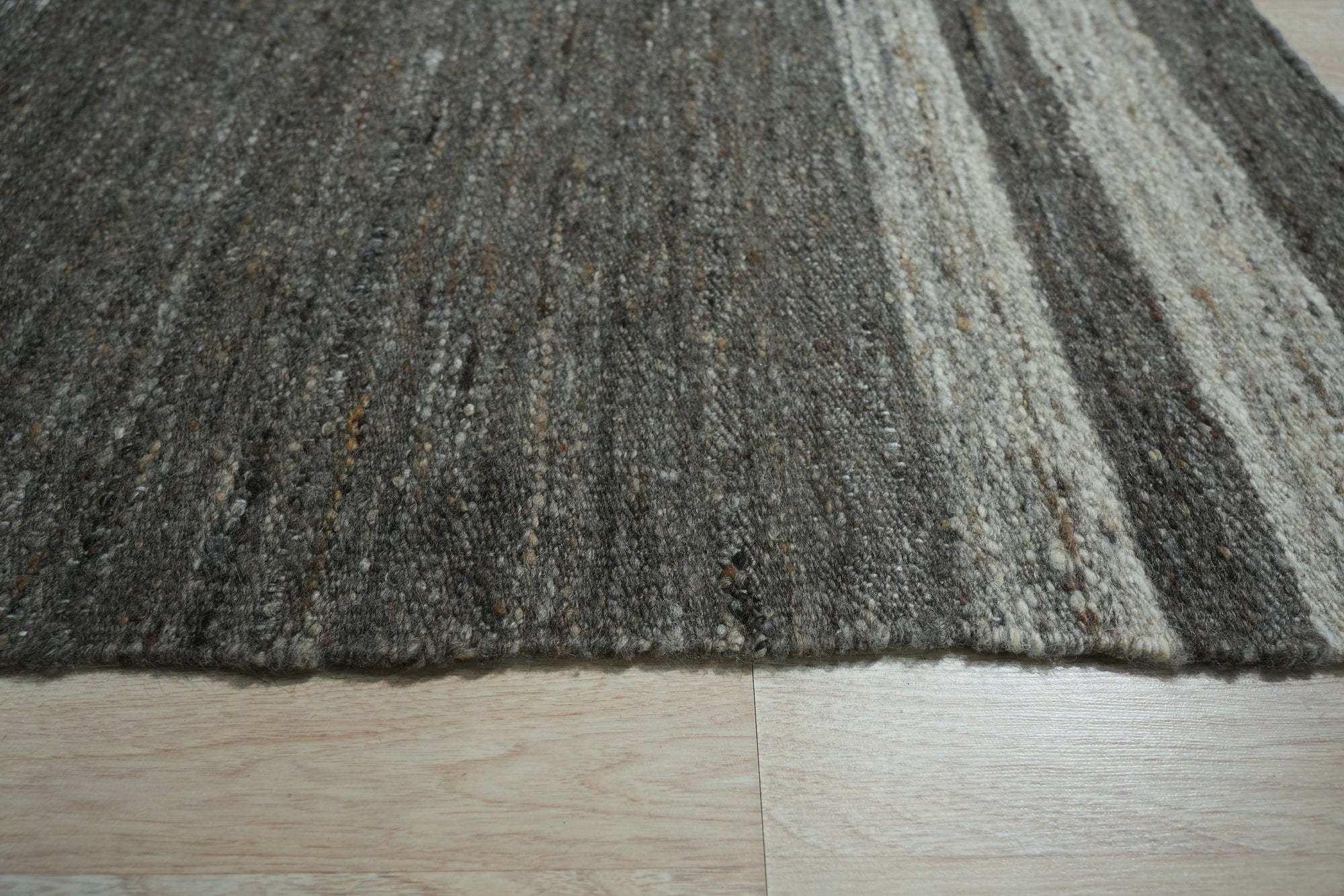 Cassandra Clara Brown Flatweave Wool Rug, warming a neutral space with its textured, earth-toned flatweave.