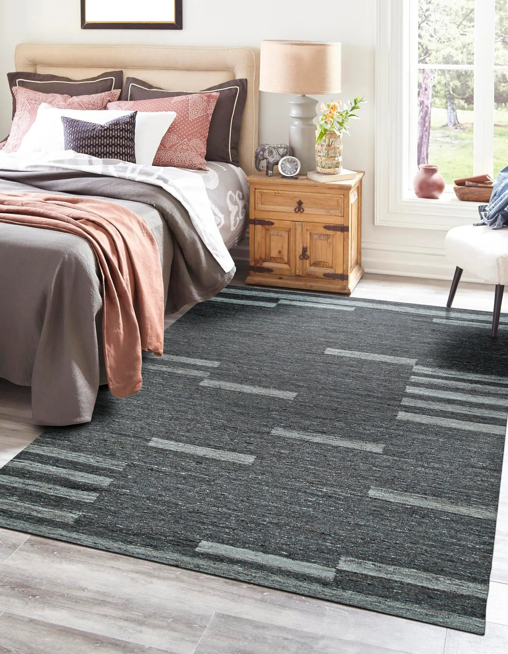 Cassandra Clara Brown Flatweave Wool Rug, showcasing its warm, neutral tones and intricate geometric pattern, blends seamlessly into a bright living room setting with contemporary furniture.