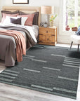 Cassandra Clara Brown Flatweave Wool Rug, showcasing its warm, neutral tones and intricate geometric pattern, blends seamlessly into a bright living room setting with contemporary furniture.