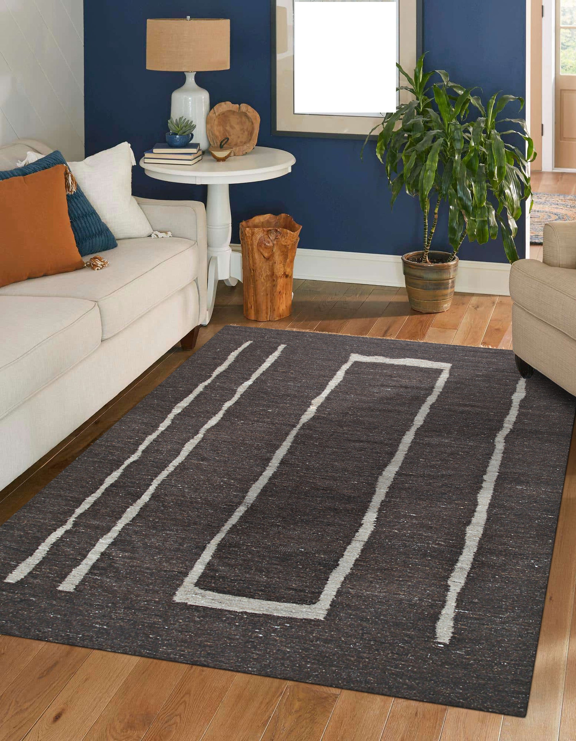 Talia Delicate Brown Flatweave Wool Rug, its subtle geometric pattern blending harmoniously within a warmly lit living room setting. Soft brown tones and flatweave texture create a inviting and sophisticated ambiance.