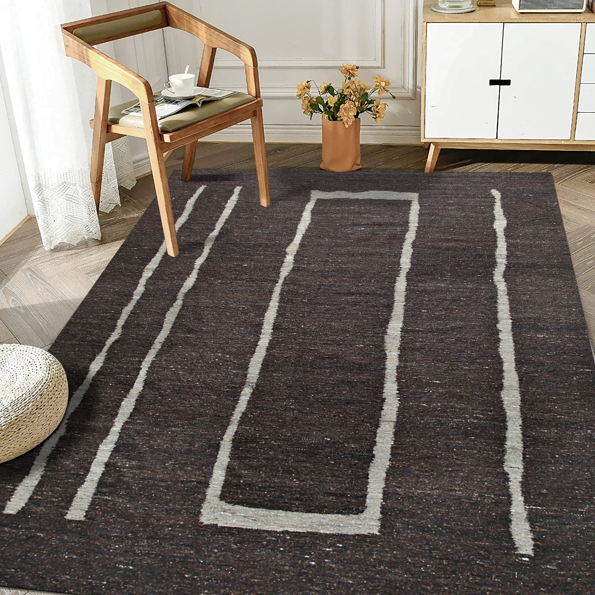 Talia Delicate Brown Flatweave Wool Rug, warming a modern living room; close-up reveals the rug's subtle brown tones and flatweave construction under natural light.
