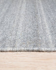 Clara Unique Gray Flatweave Wool & Viscose Rug, showcasing a subtle textured gray flatweave, likely wool and viscose blend, lending a modern, understated elegance to an unseen room.