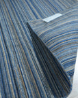 Freya Alluring Blue Handmade Rug, showcasing deep blues and swirling patterns reminiscent of ocean depths; luxuriously textured, enriching a modern living space.