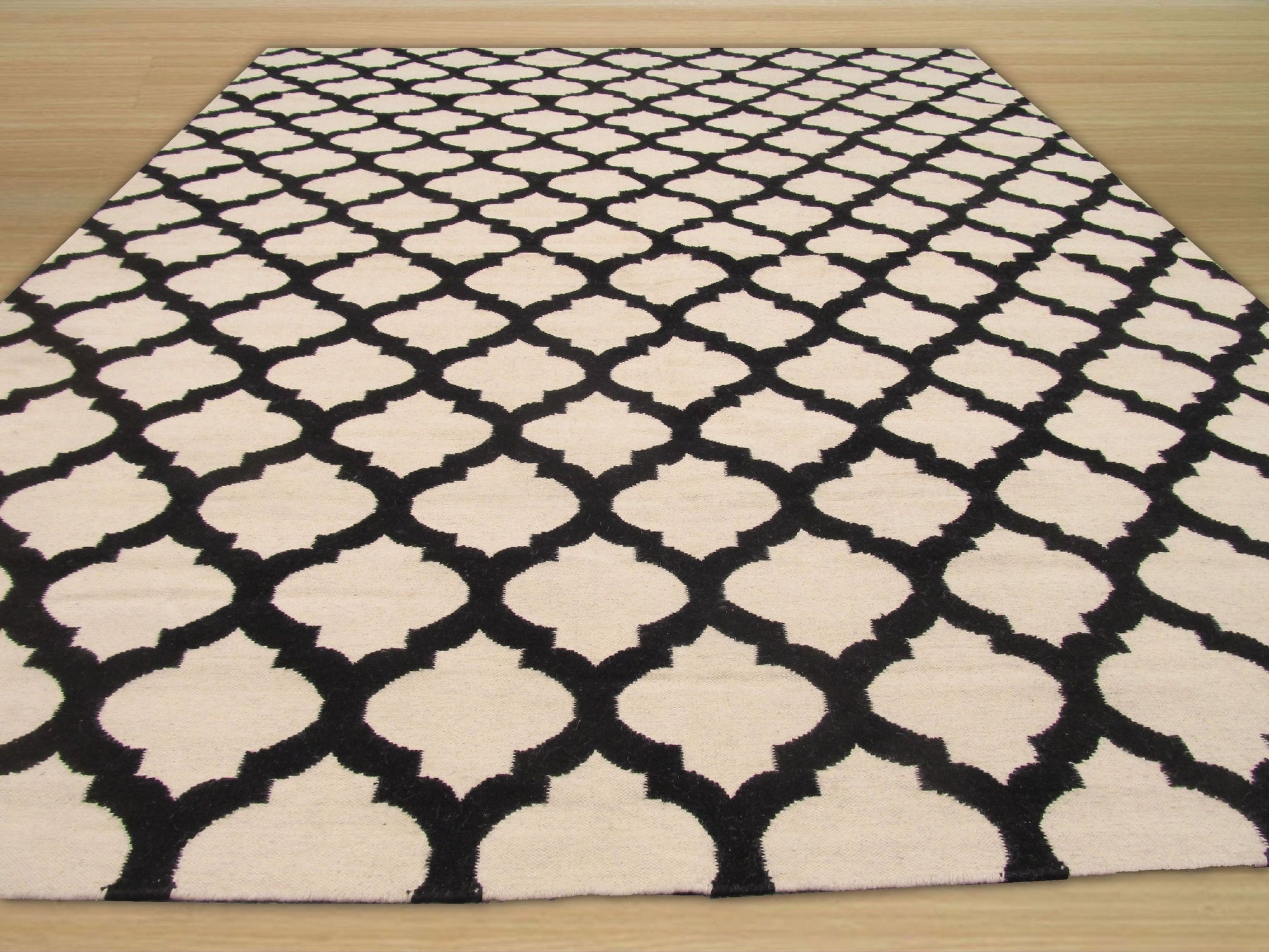 Maya Moroccan Black Flatweave Wool Rug, showcasing its geometric diamond pattern in deep black, flatwoven for a textured, minimalist aesthetic.