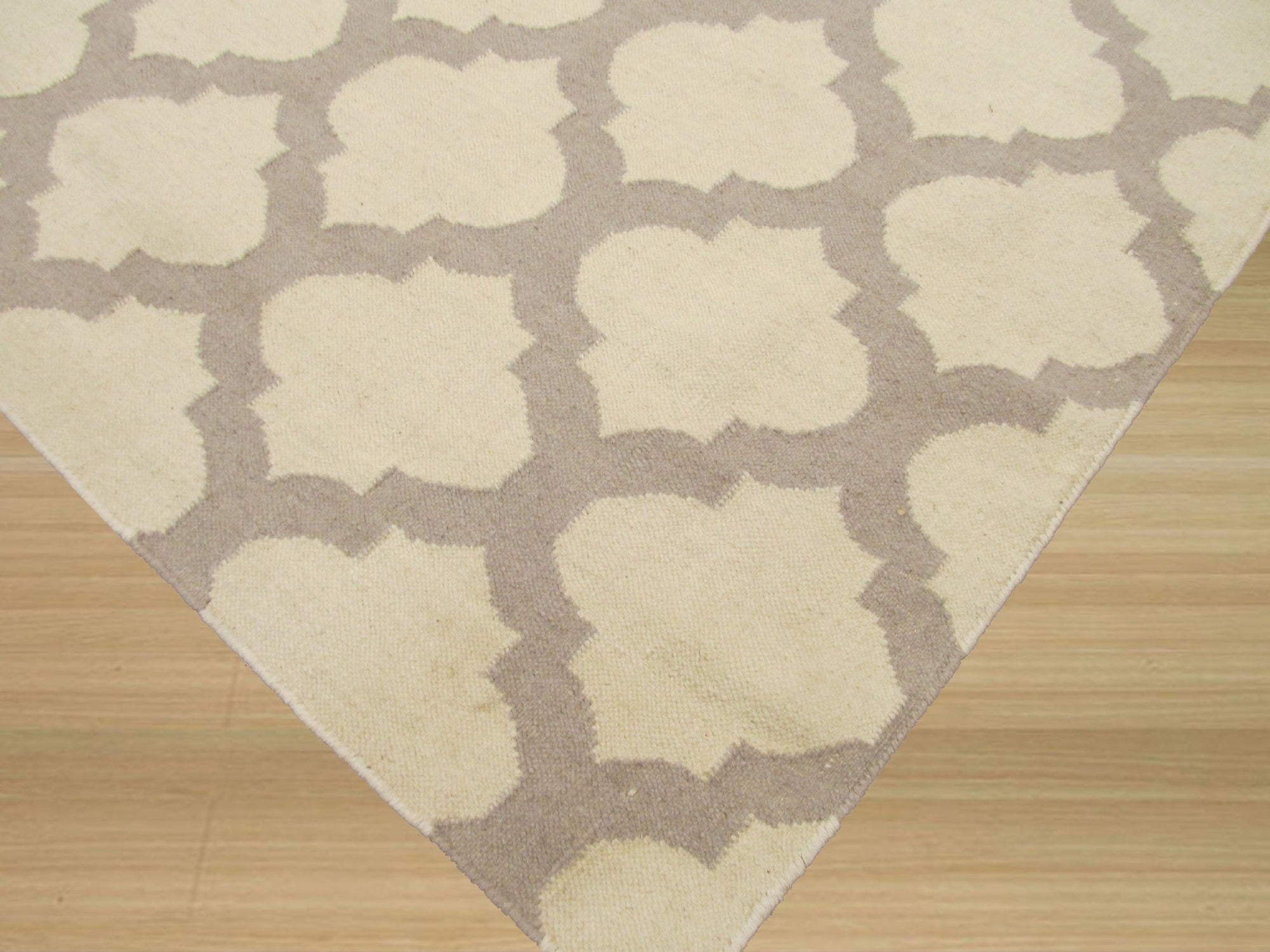 Maya Moroccan Ivory Flatweave Wool Rug, its neutral palette and subtly textured weave complement a bright, modern living space.