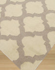 Maya Moroccan Ivory Flatweave Wool Rug, its neutral palette and subtly textured weave complement a bright, modern living space.