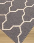 Classic Moroccan Gray Flatweave Wool Rug, lying flat on a light surface, showcasing its subtle geometric diamond pattern in shades of gray. Soft woven wool texture visible under ample natural light.