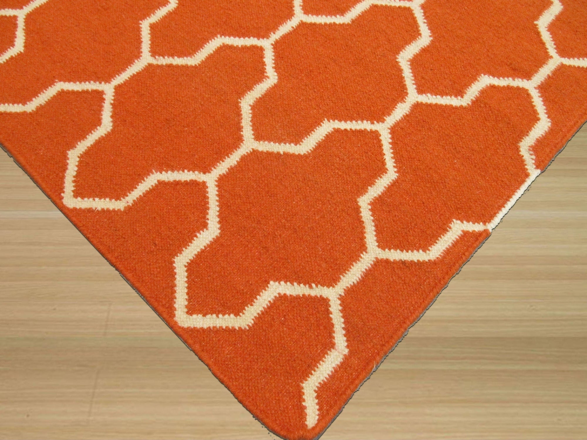 Classic Moroccan Orange Flatweave Wool Rug, showcasing its vibrant orange hues and intricate flatweave construction, displayed in a bright, naturally lit living space with neutral furniture.