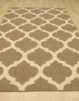 Iris Moroccan Brown Flatweave Wool Rug, woven in a neutral living space, showcasing its intricate geometric pattern in shades of brown and cream.
