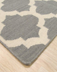 Selene Elena Gray Flatweave Wool Rug, a gray flatweave wool rug with a subtle, textured pattern, complementing a living room setting with a light-colored sofa and minimalist decor.