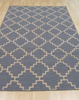 Alluring Bianca Blue Flatweave Wool Rug, a calming blue flatweave wool rug with a subtle geometric pattern, lies grounded on a light hardwood floor, evoking a sense of serene sophistication in a naturally lit space.