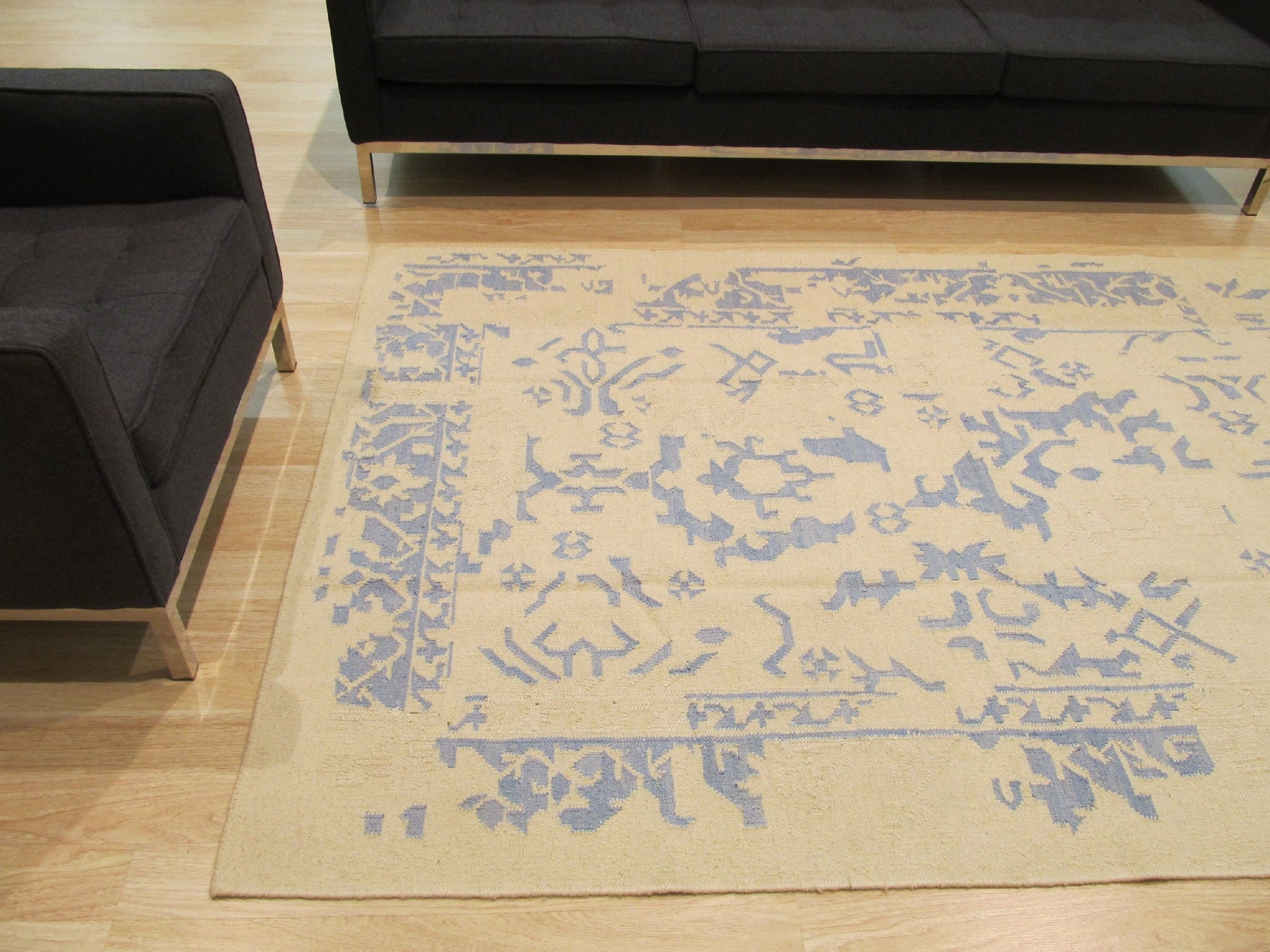 Stylish Graceful Blue Flatweave Wool Rug sits on a light hardwood floor, its cool blue tones and flatweave construction adding a touch of modern elegance to the room.