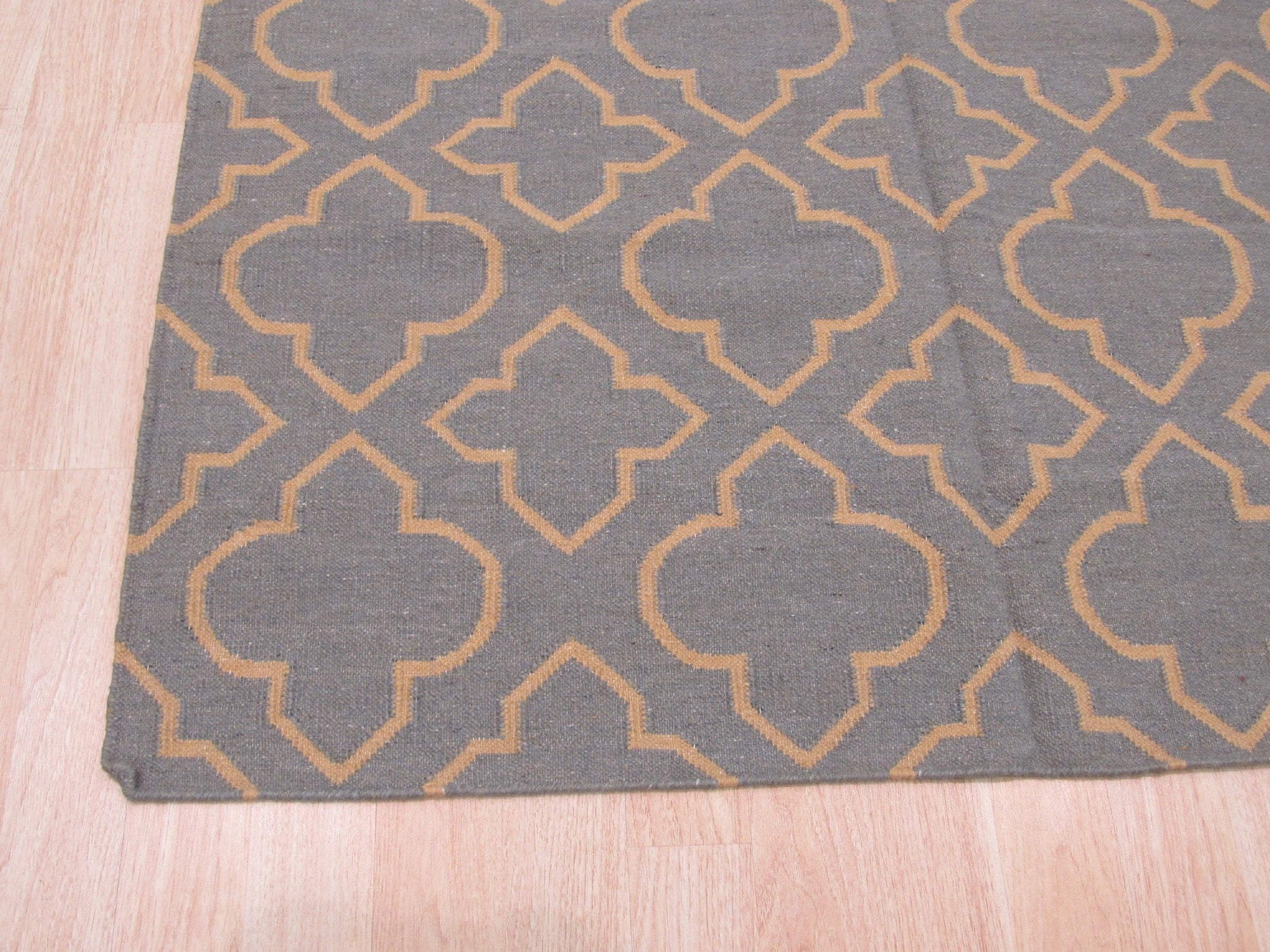 Luna Nadia Blue Flatweave Wool Rug, a cool-toned blue and ivory wool rug with a geometric pattern and flatweave construction, laid on a light hardwood floor showcasing its texture and scale.