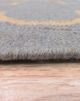 Luna Nadia Blue Flatweave Wool Rug, showcasing a textured flatweave construction with subtle blue variations, situated as part of a layered rug arrangement.