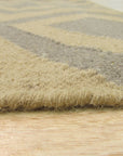 Quinn Kilim Beige Flatweave Wool Rug, showcasing its neutral beige tones and flatweave construction within a warmly lit interior, suggesting a versatile and subtly textured foundation for any room.