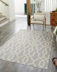 Chloe Trellis Blue Flatweave Wool Rug, showcasing a vibrant trellis pattern in shades of blue against a neutral background, lying flat in a bright living space.