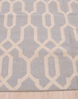 Chloe Trellis Blue Flatweave Wool Rug, showcasing a light and airy space featuring a blue trellis patterned rug with flatweave construction, anchoring a seating area with neutral furniture and ample natural light.