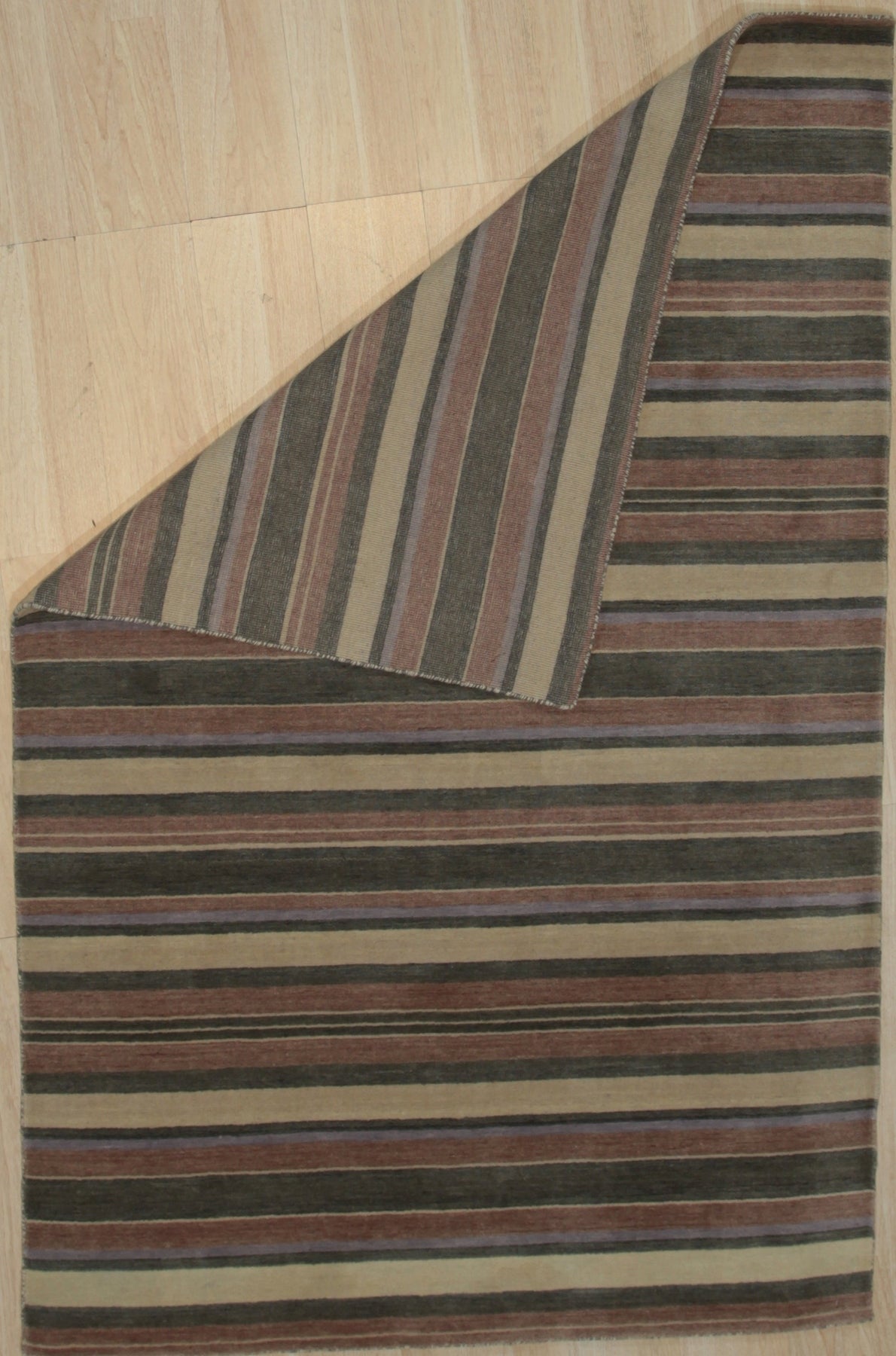 Enchanting Xena Multicolor Handmade Wool Rug, vibrant geometric patterns dance across a wool rug, bringing a burst of color and handcrafted texture to a modern living space.