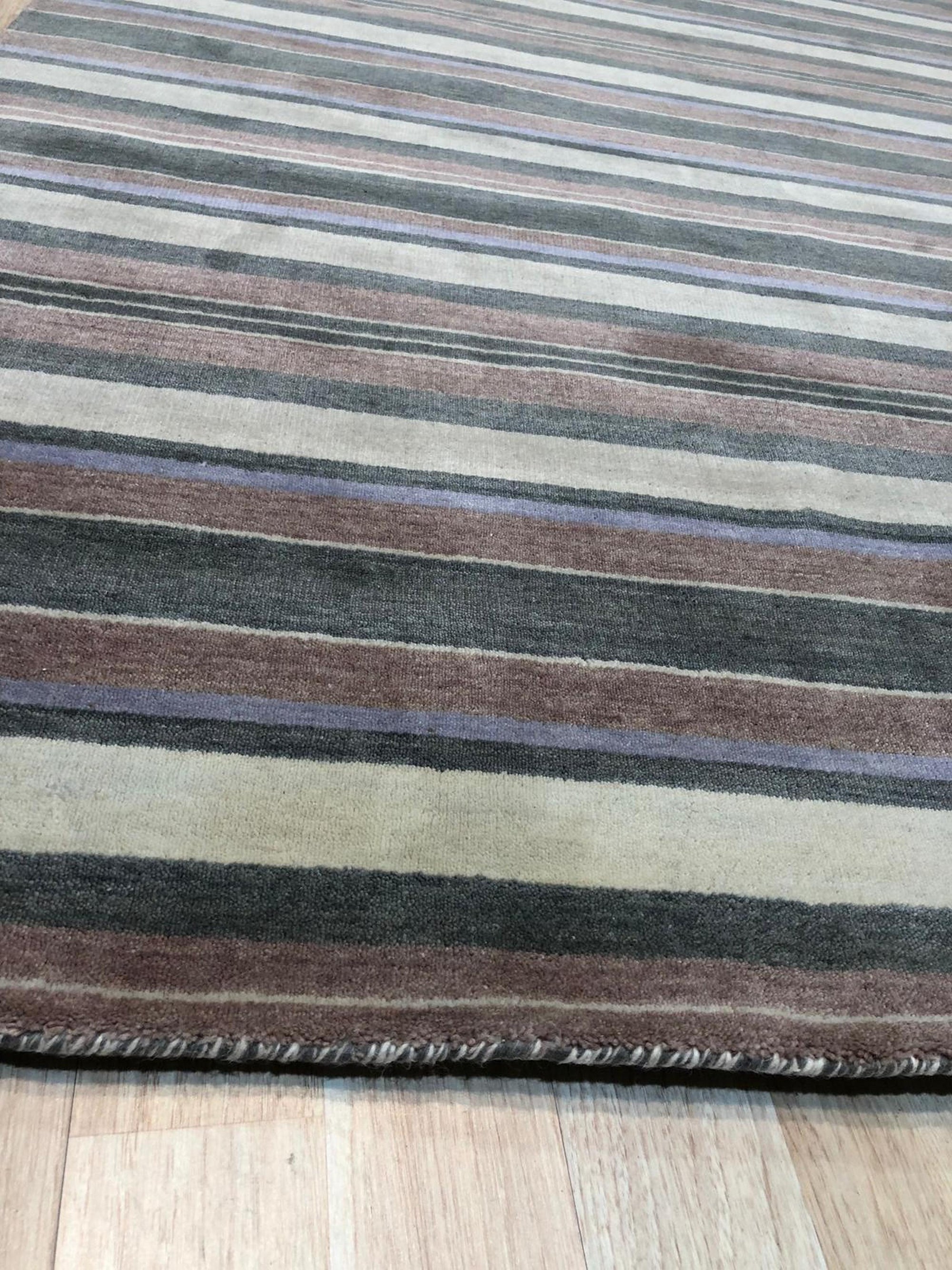 Enchanting Xena Multicolor Handmade Wool Rug, a vibrant patchwork of colorful wool rectangles, creates a modern, geometric texture across the floor, seen in a well-lit living room setting.