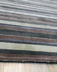 Enchanting Xena Multicolor Handmade Wool Rug, a vibrant patchwork of colorful wool rectangles, creates a modern, geometric texture across the floor, seen in a well-lit living room setting.
