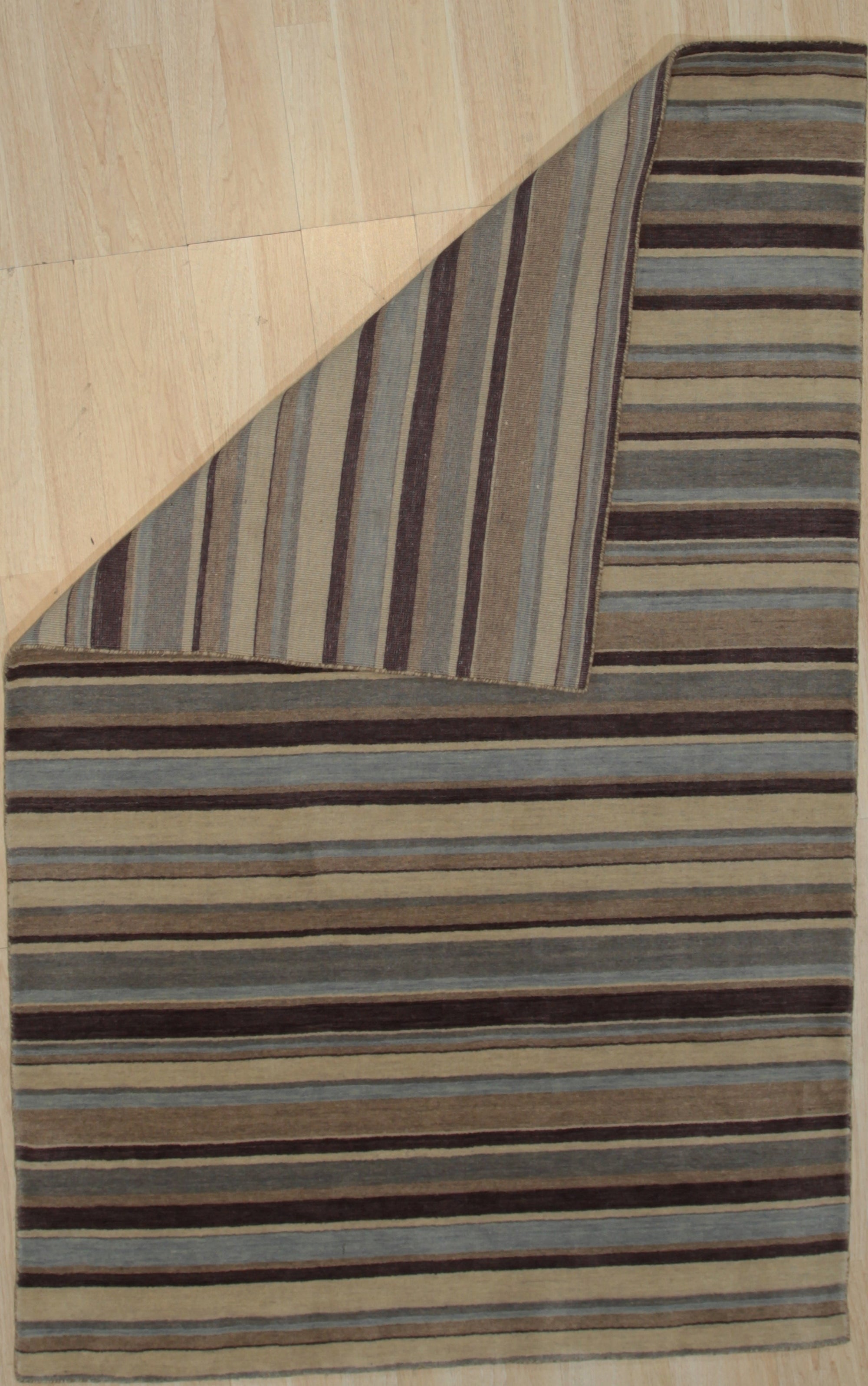 Trendy Classic Multicolor Handmade Wool Rug, vibrant blocks of color intersect in this handmade wool rug, seen in a bright, minimalist living room setting, adding warmth and texture to the modern space.