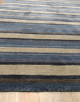 Trendy Classic Multicolor Handmade Wool Rug displayed on a light wood floor, its vibrant, geometric pattern adding warmth to the modern space.
