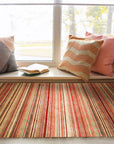 Lush Striped Red Flatweave Wool Rug, a vibrant red and cream striped wool rug with a flatweave construction, displayed in a bright, modern living space.