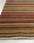 Lush Striped Red Flatweave Wool Rug, warm reds and subtle neutrals create bold stripes in this flatweave wool rug, adding a touch of cozy texture to a modern space.