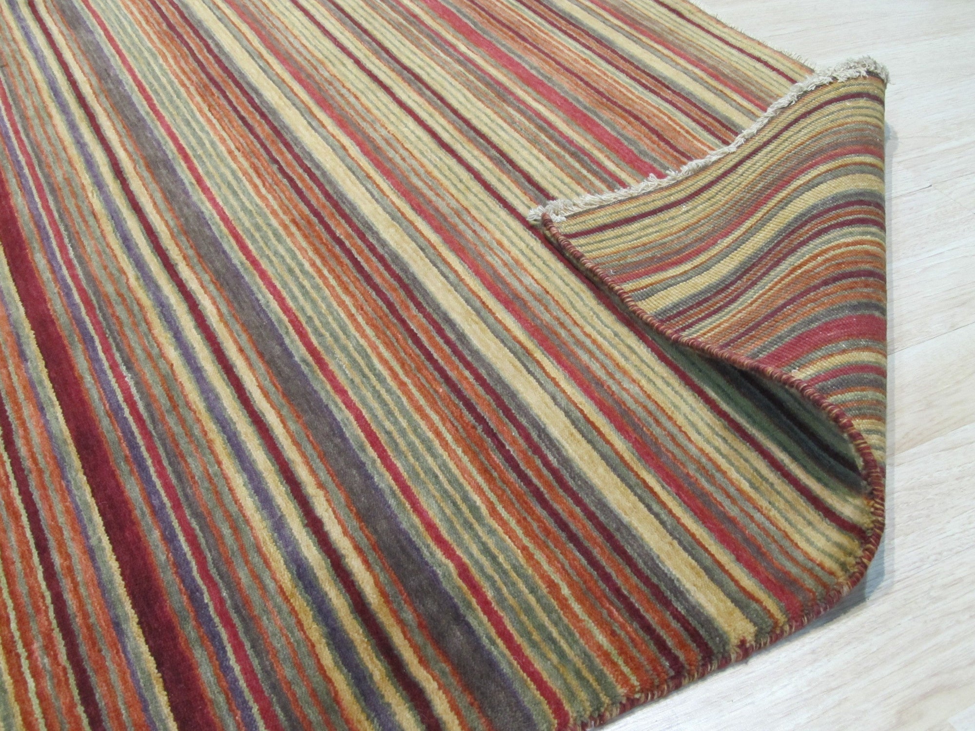 Lush Striped Red Flatweave Wool Rug, vibrant stripes of red and natural wool create a dynamic, textured surface in this flatweave rug, showcasing its handcrafted construction.