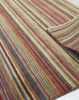 Lush Striped Red Flatweave Wool Rug, vibrant stripes of red and natural wool create a dynamic, textured surface in this flatweave rug, showcasing its handcrafted construction.