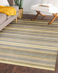 Ella Rustic Brown Handmade Wool Rug displayed in a warmly lit room; texture and intricate details are visible showcasing the rug's handmade wool construction and rustic brown tones.