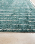 Beautiful Celia Green Hand Knotted Wool Rug, showcasing a verdant, hand-knotted texture and intricate design details, set within a styled room.