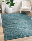 Beautiful Celia Green Hand Knotted Wool Rug, showcasing an intricate, textural floral pattern in shades of green, ivory, and subtle brown, lies flat on a light hardwood floor, its hand-knotted wool pile adding warmth and sophistication to a bright, airy space.