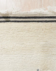 Selene Moroccan Ivory Hand Knotted Wool Rug, a luxurious textured weave in a bright, airy living room setting.