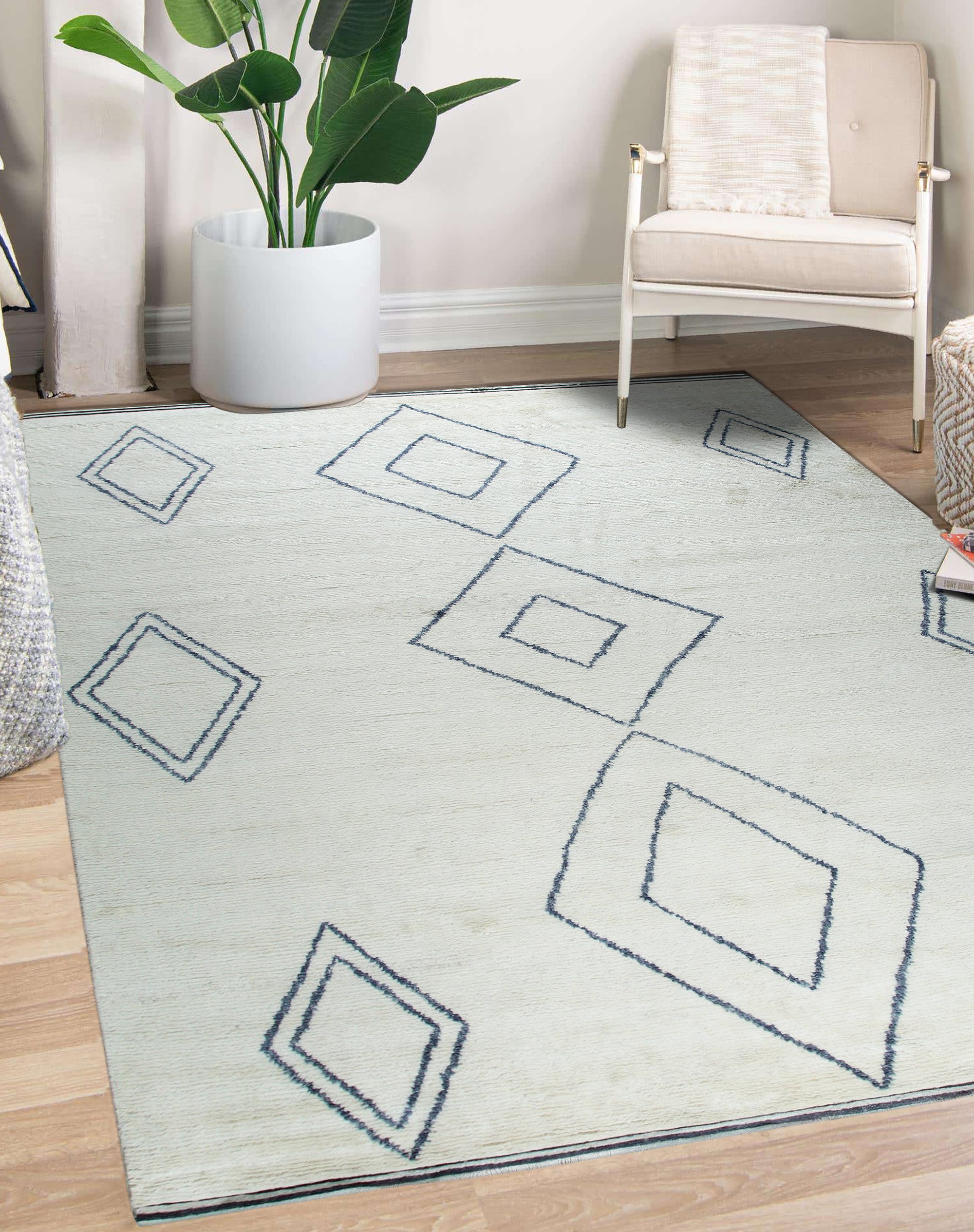 Selene Moroccan Ivory Hand Knotted Wool Rug, showcasing its plush texture and geometric design in a bright, airy living room setting.