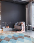 Comfortable Moroccan Multicolor Hand Knotted Wool Rug, blending vibrant hues and traditional patterns, sprawls across a warmly lit floor, its textured wool visible in soft detail.