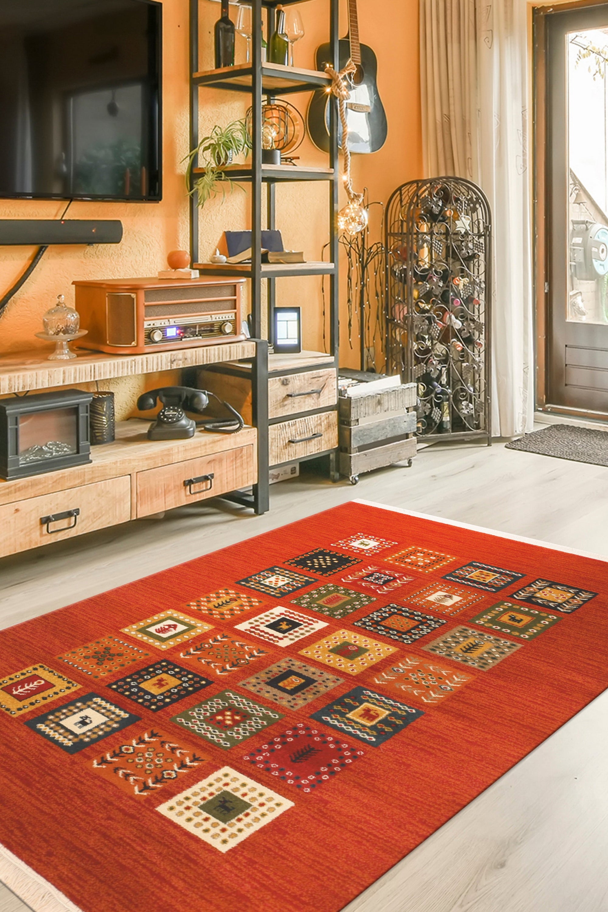 Classic Artisan Red Machine Made Wool Rug, showcasing its intricate floral medallions and borders in warm red hues, layered over a light wooden floor in a bright, inviting living room.
