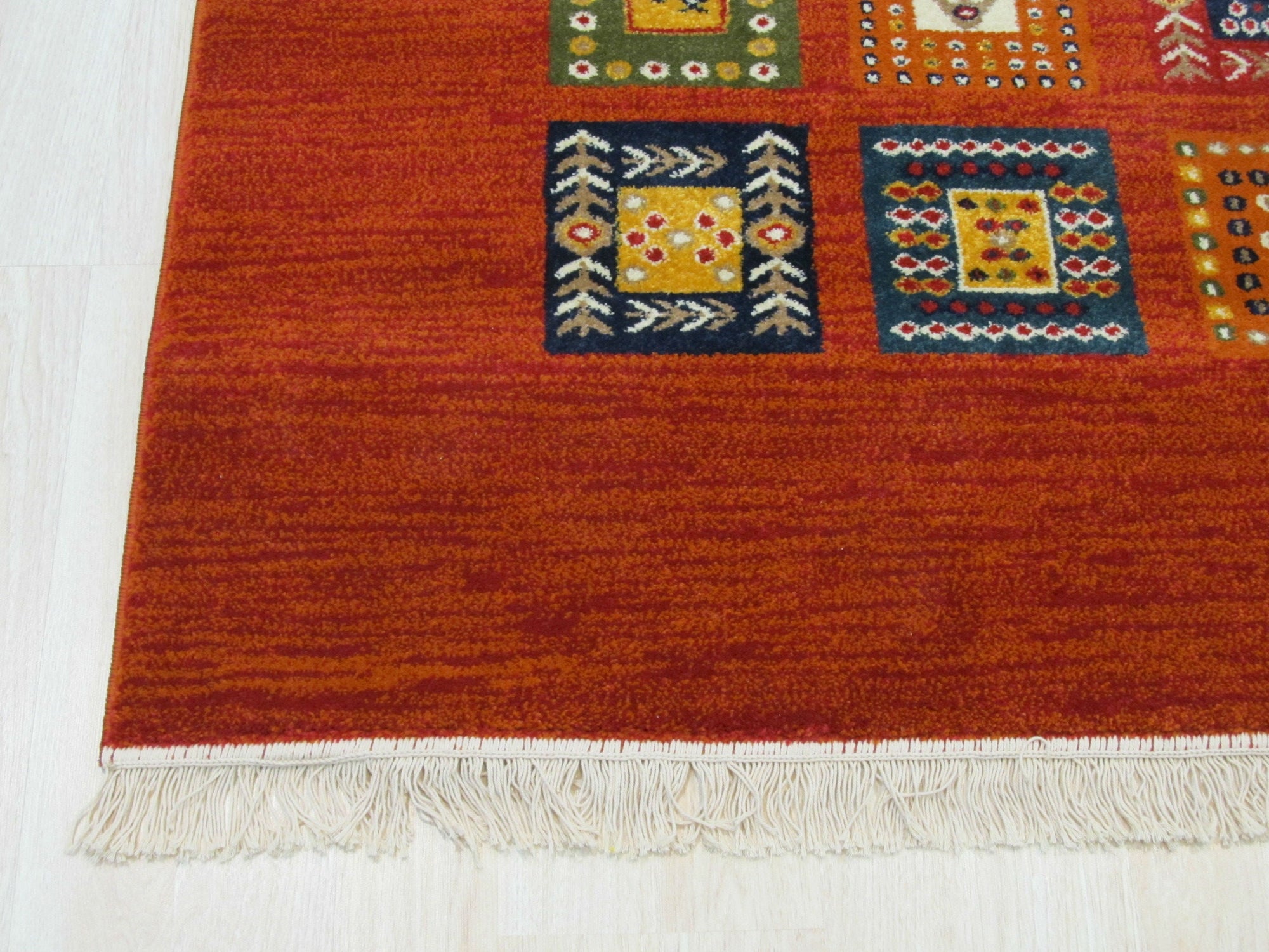 Classic Artisan Red Machine Made Wool Rug displayed in a living room setting, its vibrant red tones and intricate, traditional pattern anchoring the space. Machine-made wool construction offers both durability and a soft feel underfoot.