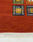 Classic Artisan Red Machine Made Wool Rug displayed in a living room setting, its vibrant red tones and intricate, traditional pattern anchoring the space. Machine-made wool construction offers both durability and a soft feel underfoot.