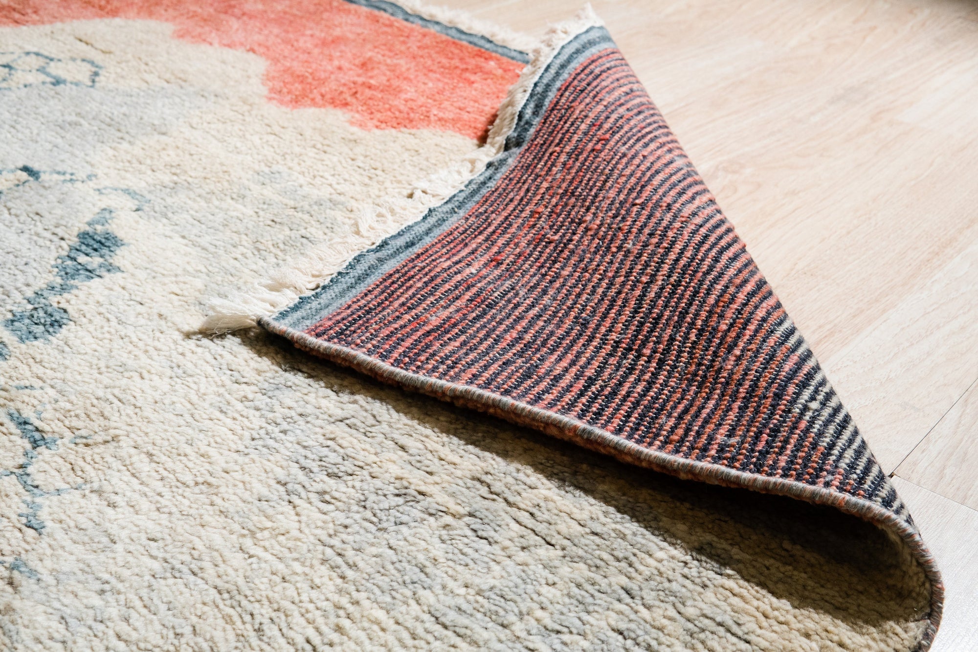 Comfortable Moroccan Multicolor Hand Knotted Wool Rug, vibrant shades dance across a plush wool surface, the intricate hand-knotted construction adding depth and texture to this colorful floor covering.