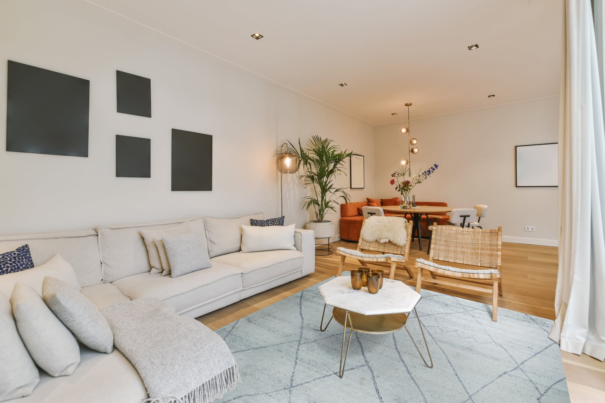 Penelope Diamond Silver Hand Knotted Wool Rug, a silver hand-knotted wool rug featuring a subtle diamond pattern, lending texture and sophistication to a bright, airy room.