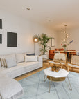 Penelope Diamond Silver Hand Knotted Wool Rug, a silver hand-knotted wool rug featuring a subtle diamond pattern, lending texture and sophistication to a bright, airy room.