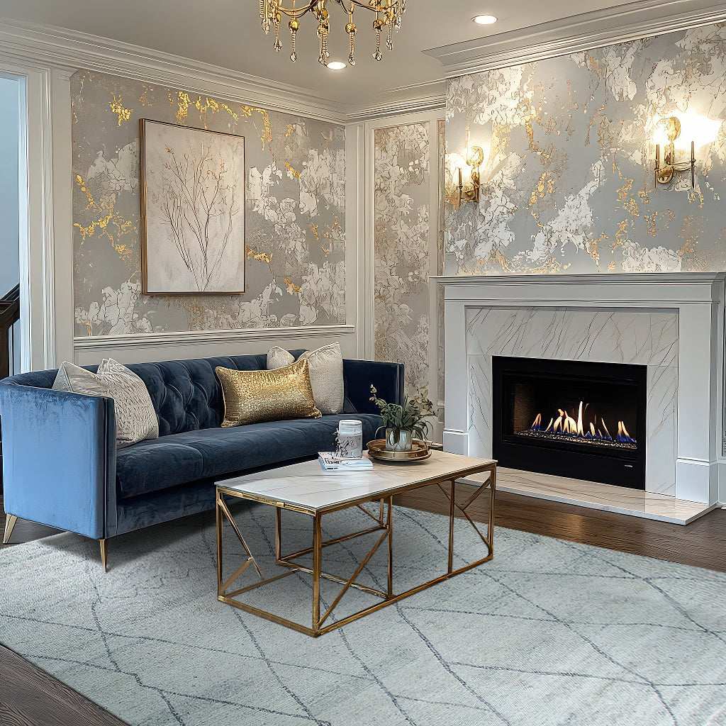 Penelope Diamond Silver Hand Knotted Wool Rug, a silver wool rug with a diamond pattern, seen in a bright living room setting under a coffee table, showcasing its intricate hand-knotted construction.