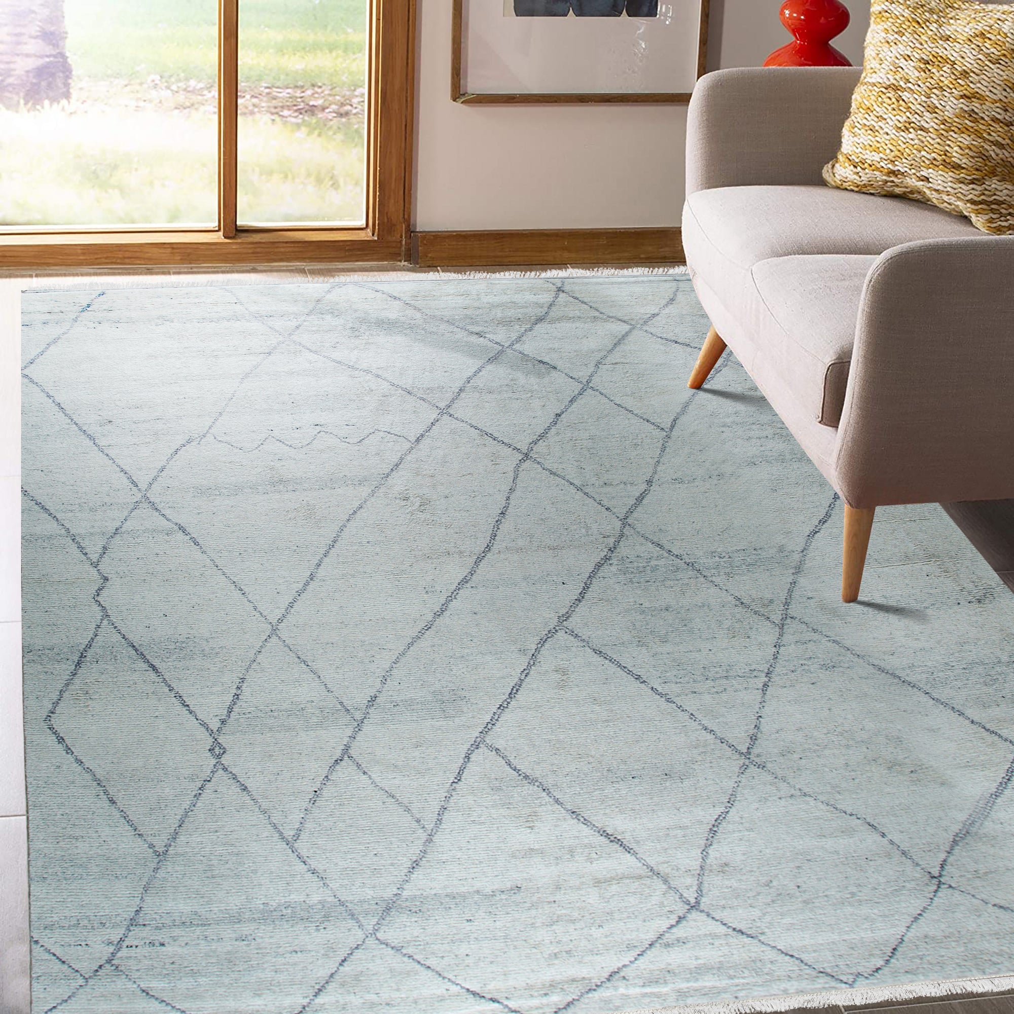 Penelope Diamond Silver Hand Knotted Wool Rug, a silver and wool rug with a diamond pattern, seen in a living room setting, adding a touch of elegance.