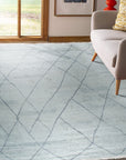 Penelope Diamond Silver Hand Knotted Wool Rug, a silver and wool rug with a diamond pattern, seen in a living room setting, adding a touch of elegance.